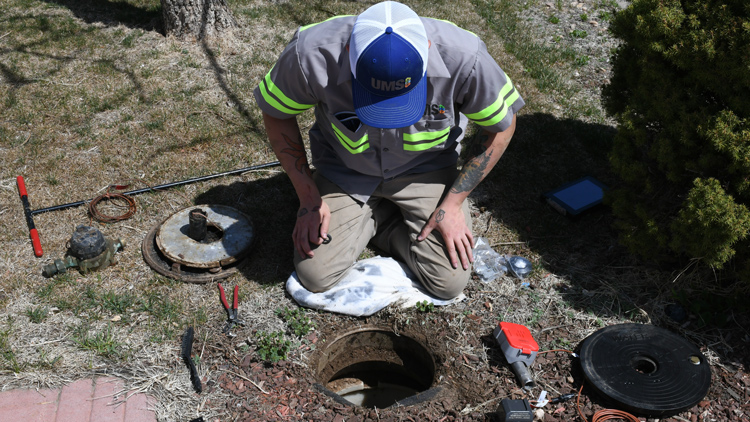 Utility Metering Solutions employee replacing a water-meter
